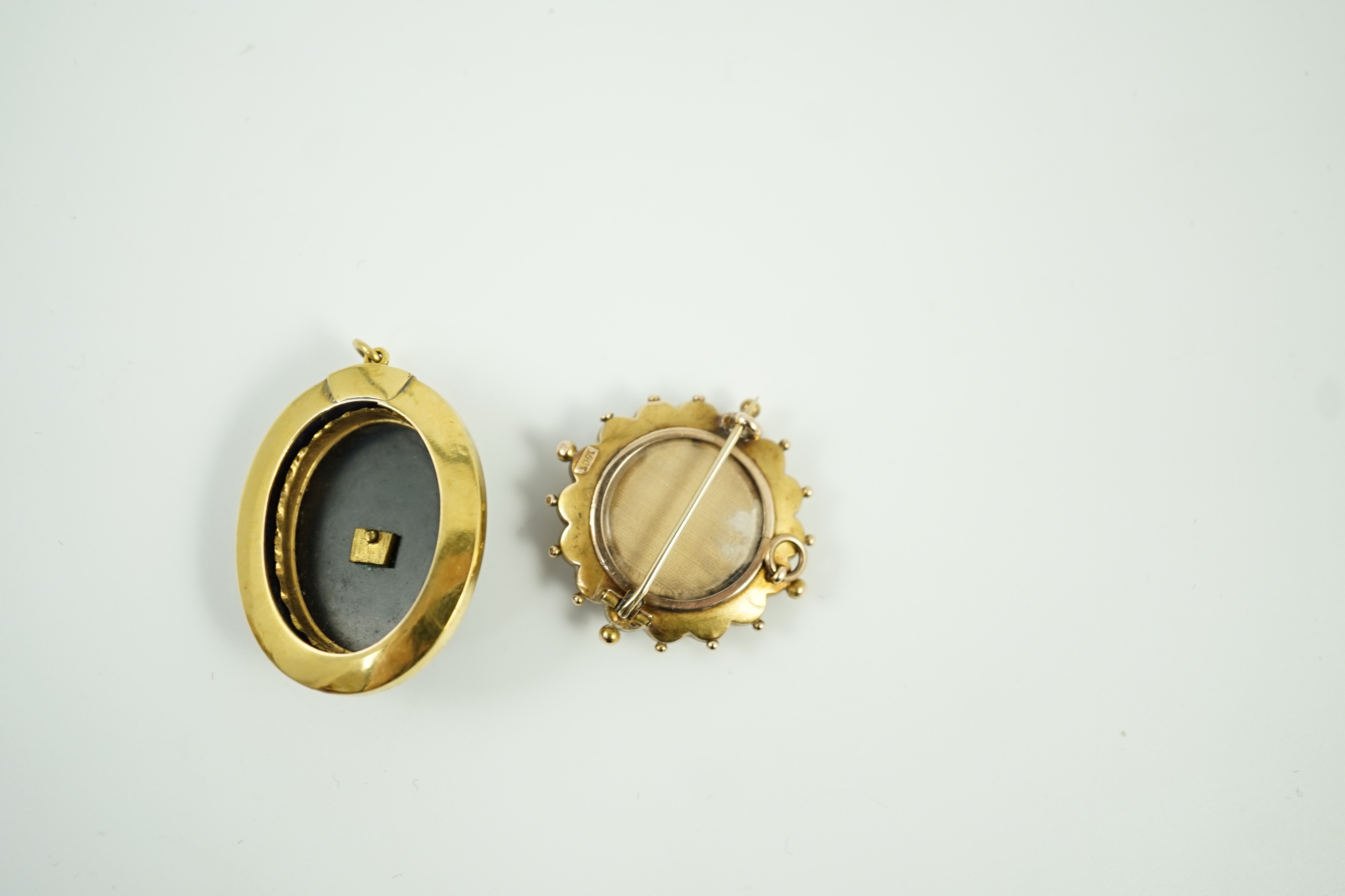 A Victorian yellow metal, black onyx, black enamel and split pearl set oval mourning pendant, 41mm and a Victorian 15ct, coral? and seed pearl set brooch, gross weight 21.5 grams.